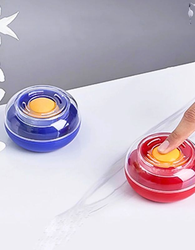 Red and blue Dingl fingertip moistener sponge cups for easier cash counting, placed on a white surface with water trail.